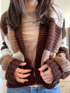 a woman is wearing a brown and white jacket