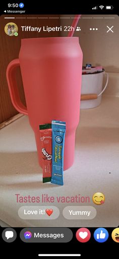 a pink coffee cup sitting on top of a counter