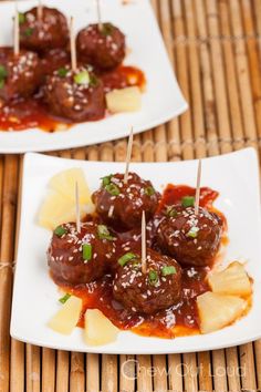 two plates with meatballs and pineapples on skewered toothpicks