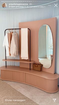 a mirror and some clothes on a shelf