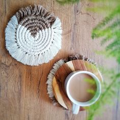 a cup of coffee next to a round rug on a wooden table