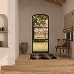 an open door leading into a room with a black and white rug on the floor