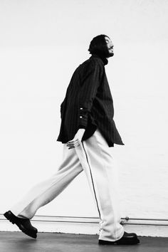 Blurred picture of a man with long hair and a beard walking. Studio shoot. Wearing a striped shirt and beige pants with a color line. Picture Of A Man, Man With Long Hair, Blur Picture, Beige Pants, Studio Shoot, Long Hair Styles Men, Color Lines, Berlin Germany, Fashion Photographer