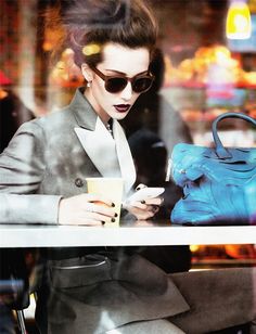 a woman in sunglasses looking at her cell phone