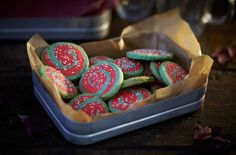 there are many decorated cookies in the tin