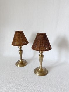 two lamps are sitting side by side on a white surface