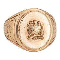 Finely detailed antique Victorian family crest signet ring (circa 1898), crafted in 10 karat yellow gold. The oval signet mount features a family crest with the year '1898' to the base. The side shoulders feature a pretty etched foliate design. The low rise ring (3.5mm - 0.13 inches) sits comfortably on the finger. The ring is in good condition with some wear evident. We have not cleaned it in order to preserve patina and collector value. Particulars: Weight: 13.5 grams Stones: N/A Size & Measurements: The ring is a size 8 1/2 (not sizable). The mount measures 18mm in length (0.70 inches) and 14mm wide (0.55 inches) rising 3.5mm from the finger. Metal & Hallmark: 10 karat yellow gold. The ring is not hallmarked though it has tested positive for 10k gold. Gold Signet Ring, Family Crest, Antique Victorian, Signet Ring, 10k Gold, A Family, Patina, Jewelry Rings, Yellow Gold