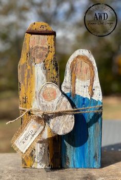 an old wooden statue is painted yellow and blue