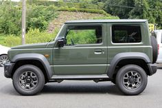 a green jeep is parked in a parking lot