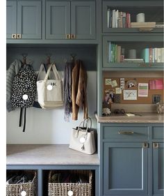 a kitchen with blue cabinets and shelves filled with purses, bookshelves and other items