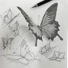 a pencil drawing of a butterfly and some other shapes on paper with a pen next to it