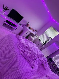 a bedroom with purple lights on the ceiling