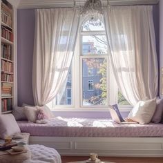 a window seat in front of a book shelf with books on it and a chandelier hanging from the ceiling