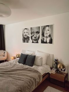 a bedroom with three black and white pictures on the wall