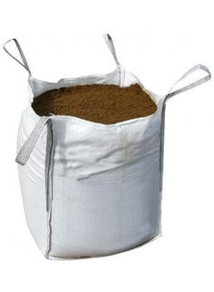 a white bag filled with dirt on top of a white table