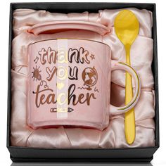 a pink coffee mug in a gift box with the words thank you teacher on it