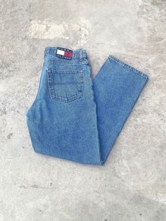 Vintage 1990s Tommy Hilfiger Blue Jeans - Size 34W x 32L - Outseam 42" Inseam 31.5" - Great vintage condition (small stain pictured) - Message for more information Please take note of the measurements listed as these are vintage clothes and may fit different than the tag size. Follow our page for more vintage clothing drops! DISCLAIMER: All items are vintage so please be mindful that if by chance there is a flaw on the item we simply may have just missed it. Inquire for more product information. 90s Style Blue Jeans, 90s Inspired Medium Wash Jeans With Pockets, 90s Style Denim Blue Jeans, 90s Tommy Hilfiger, Denim Wide Leg, Jean Large, Baggy Denim, 90s Denim, Tommy Hilfiger Jeans