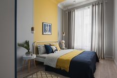 a bed room with a neatly made bed and yellow walls