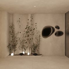 an empty room with plants and mirrors on the wall