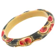 This elegant 1925s Art Deco celluloid bracelet bangle features a floral design with six motifs all around the bracelet, deeply carved, painted, and stained. The bangle boasts a lovely range of off-white, black, and red. colors Measurements: Inside across is 2.63 in diameter (6.6 cm) - outside across is 3.19 in diameter (8.1 cm) - width is 0.50 in wide (1.3 cm) - inner circumference is 8.13 in long (20.5 cm). It will best fit a Medium to Large wrist, from 6 to 7.50 in circumference (15.5 to 19 cm). Feel free to double-check the measurements and ask any questions you have before making your purchase. This item is a final sale. We will not accept returns for an unfit size. Vintage Flower Bracelet, Art Deco Bracelet, Flower Carving, 1930s Art, Red Bracelets, 1930s Art Deco, Floral Accessories, Funky Jewelry, Jewelry Lookbook