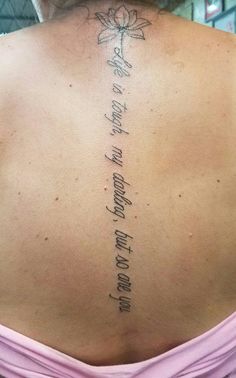 the back of a woman's neck with an inscription on it