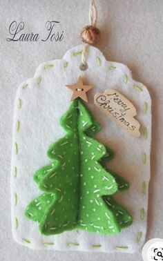 a green christmas tree ornament hanging from a string