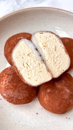 three pieces of bread sitting on top of each other in a white bowl next to a marble counter