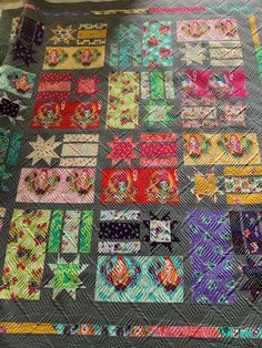 a quilted table top with many different designs on it