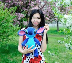 a woman holding a stuffed animal in her hands