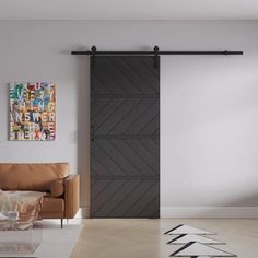 a living room with a couch, chair and sliding barn door in the middle of it