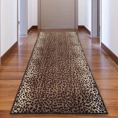 a leopard print rug is on the floor in front of an open door and doorway