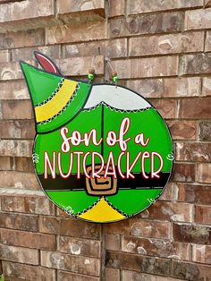 a neon sign that says son of a nutcracker on the side of a brick wall