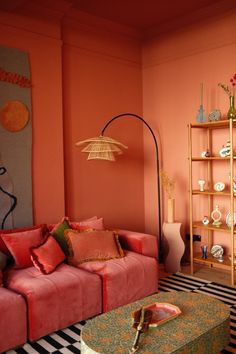 a living room with pink couches and black and white striped rugs on the floor