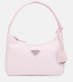 Prada delves into its extensive archives to create this Re-Edition 2000 Mini shoulder bag. The style is made from signature nylon in pastel pink, and accented with an enameled triangular logo plaque..Material: polyamide.Lining: fabric.Made in Italy.Designer color name: Alabastro.Top handle.Closure: zipped top.Internal details: fabric lining.Trim: cow leather.Height 12cm-4.5'.Width 23cm-9'.Depth 6cm-2.5'.Length of handle 33cm-13' Pink Designer Bags, Prada Bags, Prada Small Bag, Prada Pink Bag, Prada Bag Pink, Pink Prada Bag, Prada Re Edition 2000, Prada Purses, Expensive Bag