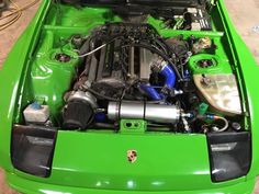 the engine compartment of a green sports car