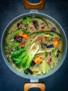 a pan filled with vegetables and sauce on top of a table