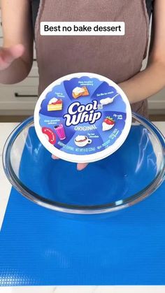 someone is holding up a bowl that says cool whip on the front and back of it