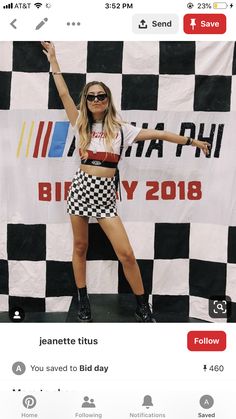 a woman standing on top of a black and white checkerboard background with her arms in the air