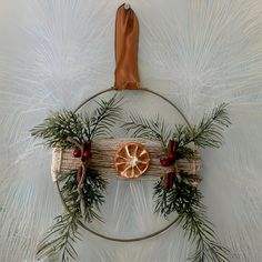 a wreath with orange slices and pine branches