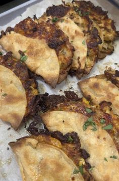 some food that is on top of a pan and has been cut into eight pieces