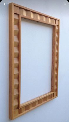 a wooden frame hanging on the wall