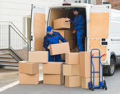 two men unloading boxes from the back of a van