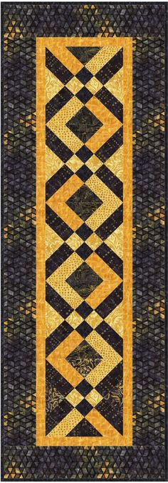 a black and yellow quilt with an abstract design