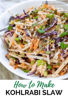 a white bowl filled with coleslaw and sprouts on top of a table