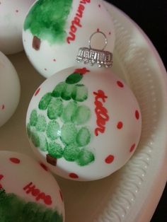 an image of christmas ornaments on a plate with red and green paint splatters