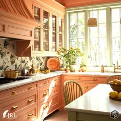 a kitchen with orange cabinets and white counter tops in front of a window filled with potted plants