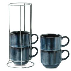 two blue coffee mugs are stacked on each other with metal holders in the middle