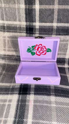 a purple box with a rose painted on it