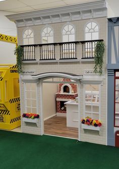 a doll house with furniture and accessories on display