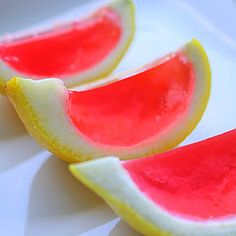 three slices of watermelon on a white plate